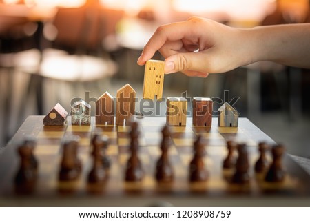 Building and house models in chess game, Business financial district and commercial , success and leadership business concept. Royalty-Free Stock Photo #1208908759