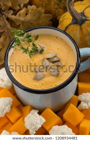 Cream soup. Pumpkin and cauliflower soup. Homemade. Cream soup in a mug. Cream soup with vegetables. Sunny picture. Autumn. Pumpkin. Cauliflower.