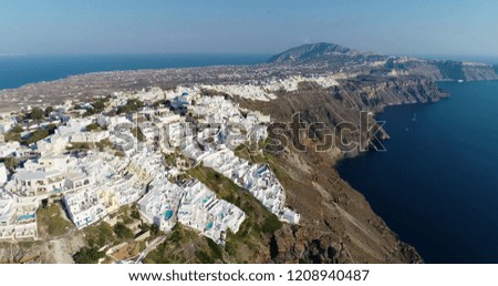 village and villa with swimming pool on the island of Santorin in aerial view