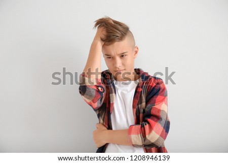 Bothered teenage boy on white background