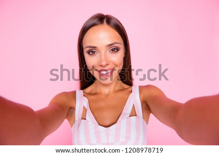 Portrait of attractive sweet good-wearing lady with her brunette hair she make selfie hold camera two hands isolated on vivid pink pastel background make beaming toothy smile