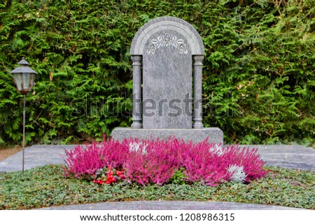 Blank gravestone of a dead person on a cemetery. Ideal for messages and names Royalty-Free Stock Photo #1208986315