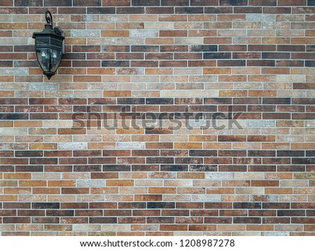 old style lamp on brown brick wall