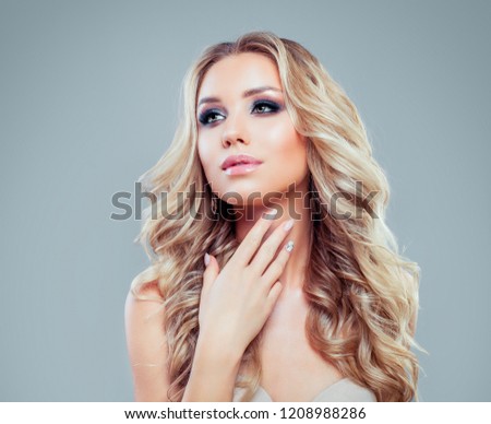 Perfect blonde woman with healthy hair and makeup on blue background