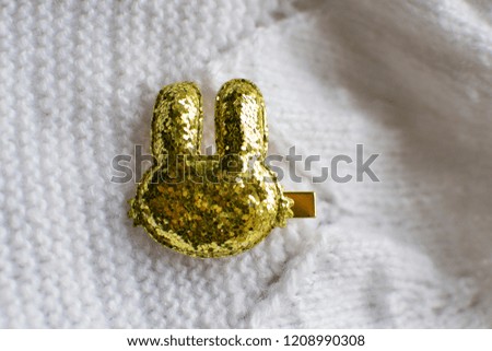 Golden hairpin for handmade hair in the shape of a rabbit. on a white background