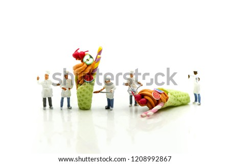 Miniature people : Chef is decorating ice cream with mint and strawberry,cherry,snack