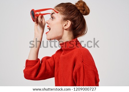 woman in a sweater with glasses looks away                        