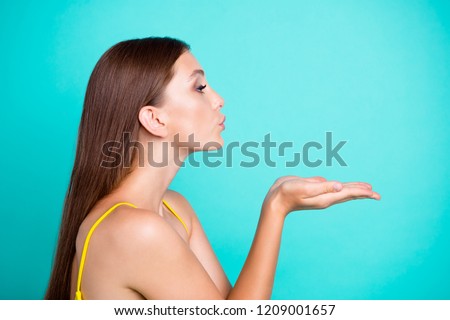 Profile side view portrait of nice positive attractive cute sweet tender straight-haired girl, sending air kiss, isolated on green turquoise background Royalty-Free Stock Photo #1209001657