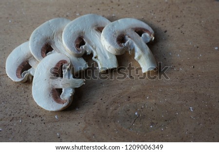 sliced mushrooms, champignons on a wooden board brown