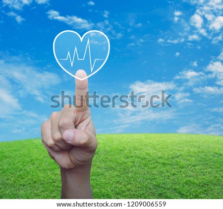 Heart beat pulse flat icon over green grass field with blue sky, Business medical health care service concept