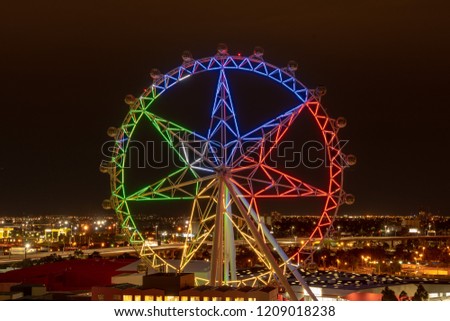 City light and observation wheel at night Royalty-Free Stock Photo #1209018238