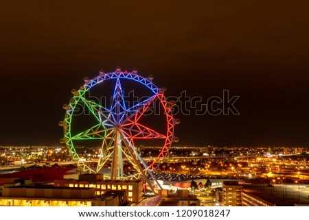 City light and observation wheel at night Royalty-Free Stock Photo #1209018247