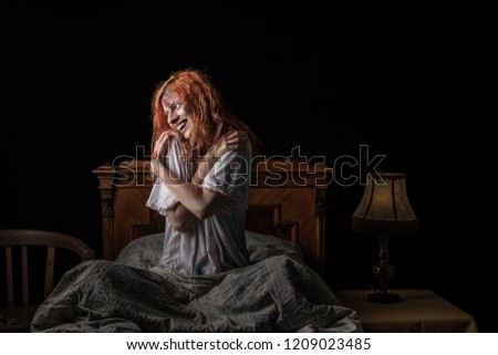 Scary woman possessed by devil in the bed. Exorcism of priest. 