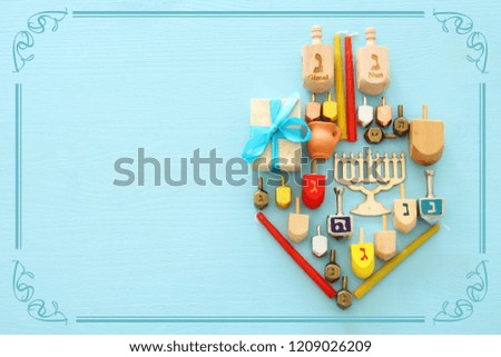 Top view image of jewish holiday Hanukkah background with traditional spinnig top, menorah (traditional candelabra) and candles