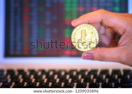 Cryptocurrency Litecoin (LTC) in businesswoman hand close up.business concept.