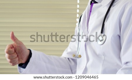 Male doctor showing thumbs up. Healthcare concept