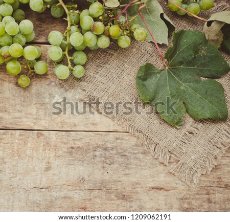 Grape bunches on a wooden abckground/toned photo