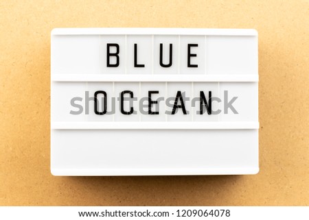 Light box with word blue ocean on wood background