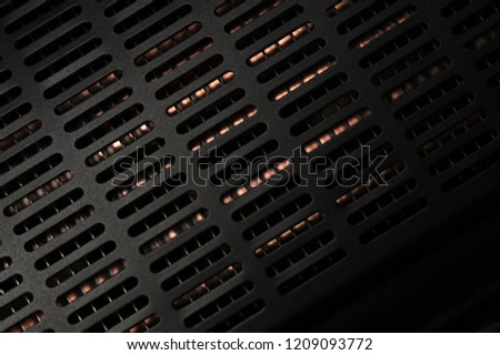 Close-up - side panel grid of a professional black studio illuminator. Photo studio equipment concept