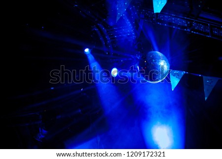 Disco ball with bright blue rays, night party background photo