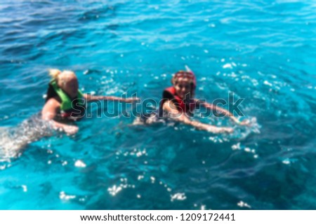 Beautiful blurred blue sea bathing game. Ocean theme with people for background. Stock photo for tourist design