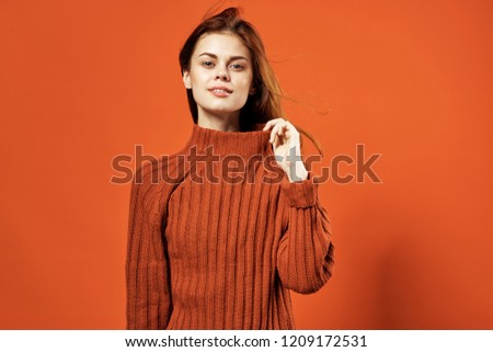 woman in orange sweater                               