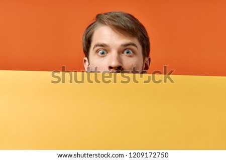  orange sheet of paper man eyes wide open                              