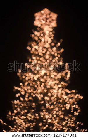 Garland decoration and illumination, blurred background. Xmas party celebration. New year tree blurry sparkling. Winter holiday and vacation. Christmas tree bokeh silhouette with decoration garland.