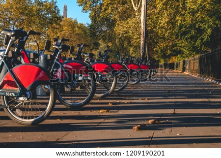 Public bicycle's lined up and ready to hire during sunrise in London, UK. Royalty-Free Stock Photo #1209190201