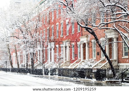 Snowy winter street scene with historic buildings along Washington Square Park in Manhattan, New York City NYC Royalty-Free Stock Photo #1209195259