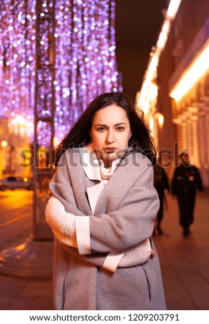 The girl walks around the evening city with lighted lanterns in the autumn