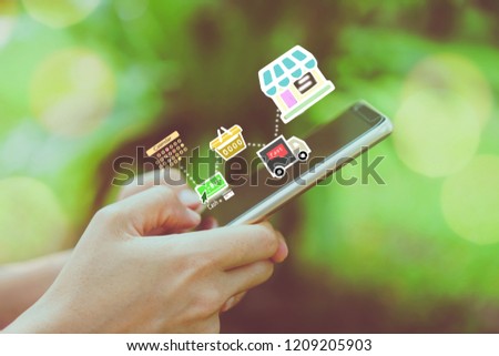 Women hand using smartphone do shopping online store with various doodle icons pop up. Social media maketing concept.