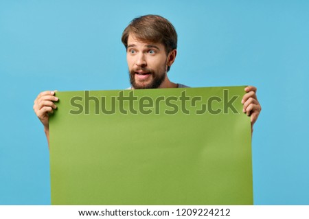green sheet of paper in the hands of a man mockup, poster                               