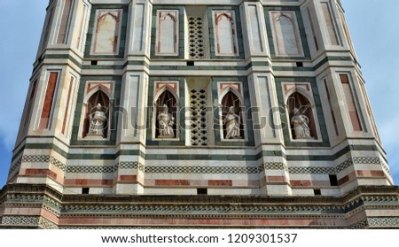 Gothic architecture. Giotto's Campanile. Tower is divided into five stages. It has rich sculptural decorations, sculptures and polychrome marble encrustations. The middle level. Italy, Florence. 