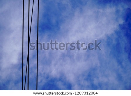 Cloudy blue sky and electric wire.