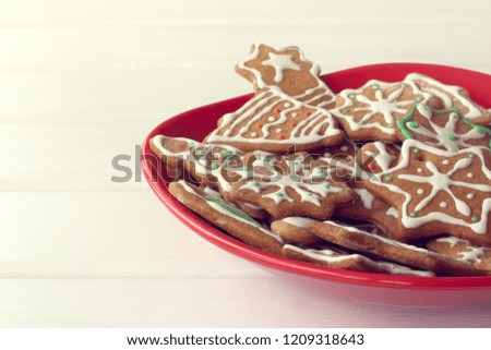red plate full of different shaped cookies on the table front view / festive dessert for Christmas