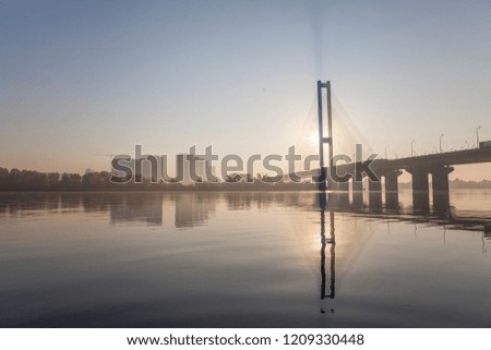 morning landscape with a bridge against the backdrop of the rising sun