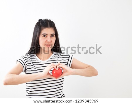 Love and business theme a young beautiful girl heart red isolated on white background in studio