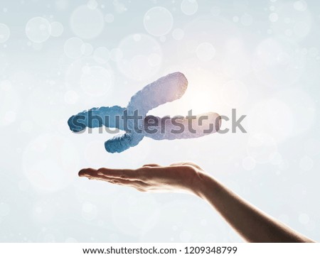 Close of human hand showing DNA molecule bokeh background