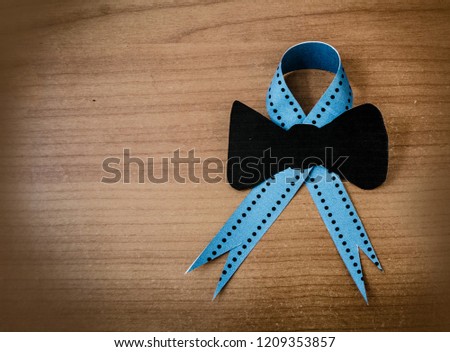 Blue november, prostate cancer awarenes month poster, blue ribbon on wooden background