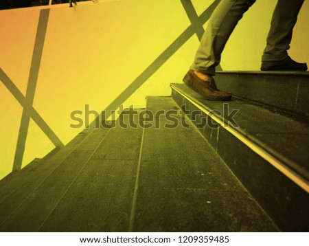 People were walking up the stairs to the building with the sun in the evening. selected focus , blurred the leg and motion moving