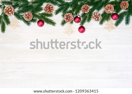 Festive composition of Christmas decorations on white wooden background. Flat lay with copy space. New year holiday frame. Royalty-Free Stock Photo #1209363415