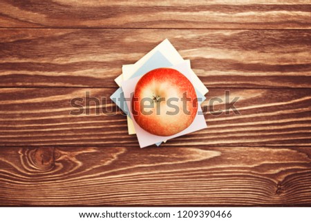 Apple and stickers on wooden background with copy space top view.