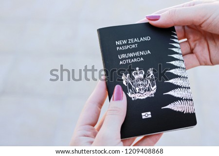 New Zealand passport in hand