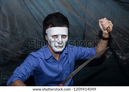 The man holding a long knife with Saw blade, killer concept, horror theme , Halloween concepts