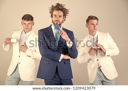 Business team on grey background. Communication and partnership. Banking and saving concept. Three men holding blank cards. Group of businessmen wearing formal suits.