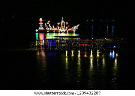 Traditional floating fire boat in Mekong river at night with light lamp as for Wan Ok Phansa is the last day of the Thai-Laos observance of Vassa at Nong Khai, Thailand on October 22, 2018: