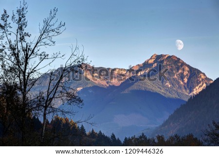 waxing moon rise before sunset above Mt McGuire, Chilliwack, BC, Canada