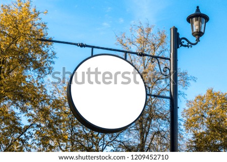 Blank round signboard, advertising, information board on pole in the park