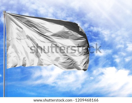 flag of White on a flagpole in front of blue sky